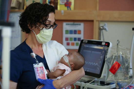 Healthcare provider holding baby