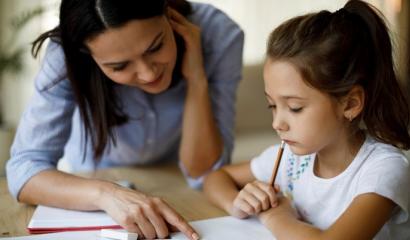 Child and mother doing schoolwork