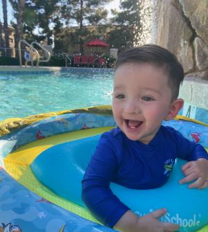 Smiling toddler in swimming pool