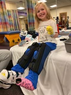 Girl in leg braces in hospital room
