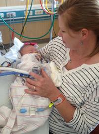 Mother holding newborn in hospital