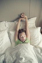 Child stretching while still in bed