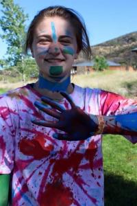 Girl in tie-dyed shirt with pain on her face