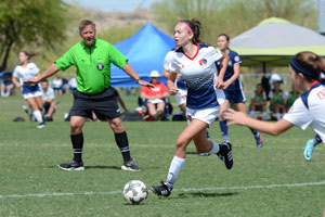 Teen girl playing soccer