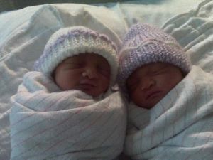 Newborn twins wrapped in striped blankets
