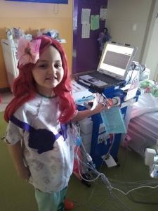 Girl dressed as The Little Mermaid in hospital