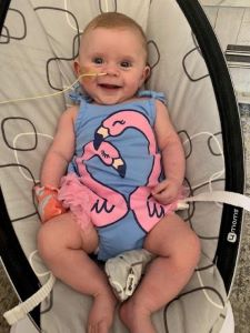 Smiling infant in bouncy seat