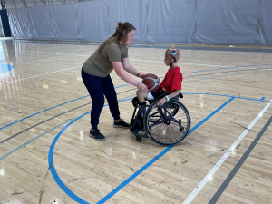 Boy in wheelchair playing basketball