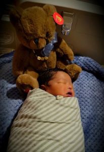 Newborn wrapped in striped blanket