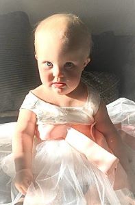 Toddler in white dress
