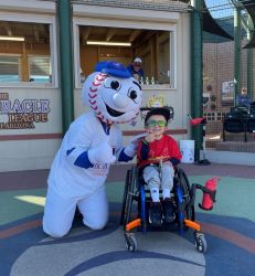 Boy in wheelchair with baseball mascot