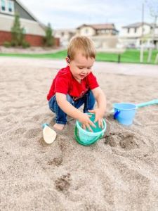 Toddler playing in sand
