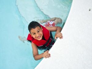 Boy wearing a lifejacket in the pool