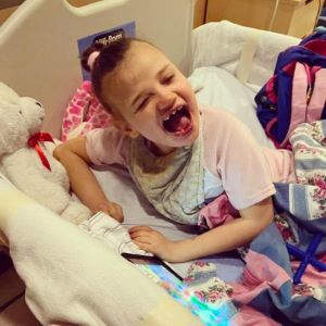 Smiling girl in hospital bed