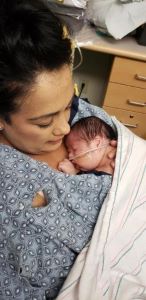 Mother holding newborn in hospital