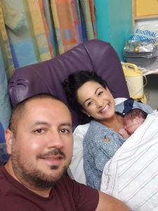 Selfie of mother, father an newborn in hospital