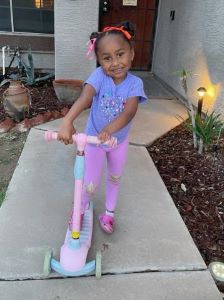 Child with pink scooter