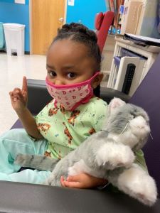 Child in hospital gown and mask