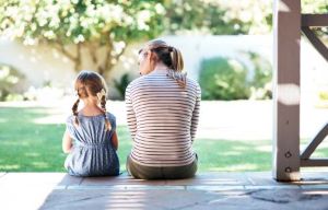 Mother and child sitting on patio