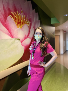 Masked nurse in pink scrubs