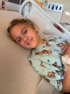 Girl lying in hospital bed