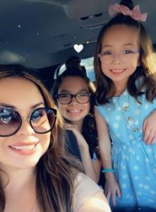 Two girls and mom in glasses, smiling