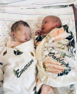 Twin babies wrapped in floral blankets