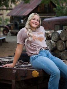 Teen girl sitting on truck bed
