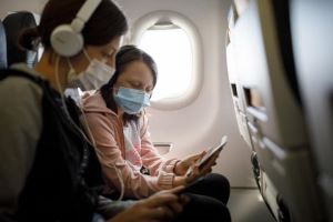 Masked travelers in an airplane