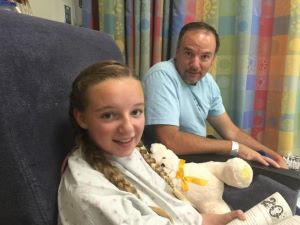 Girl and father in hospital waiting area