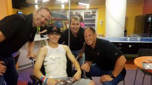 Teen in wheelchair posing with Arizona Diamondback players