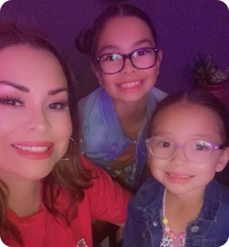 Two girls and mom in glasses, smiling
