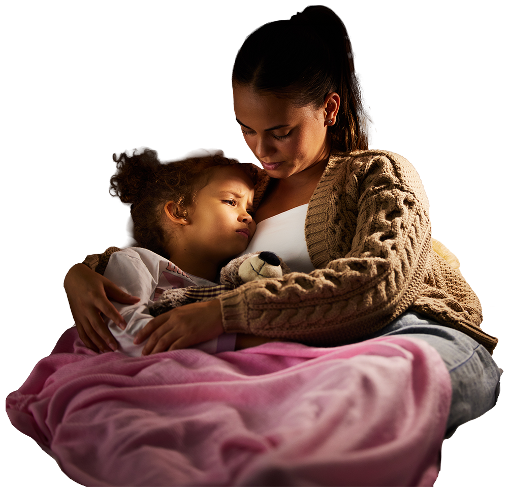 Mother holding daughter at night