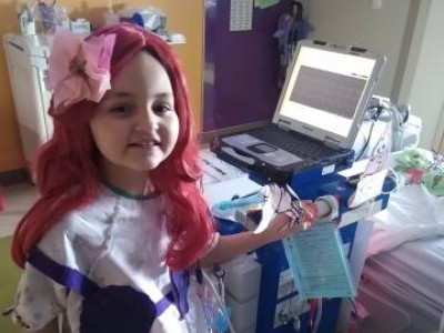 Girl dressed as The Little Mermaid in hospital