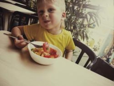 Child eating a bowl of fruit