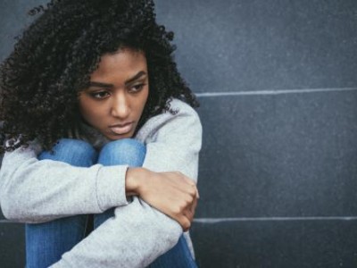 Teen girl hugging her knees