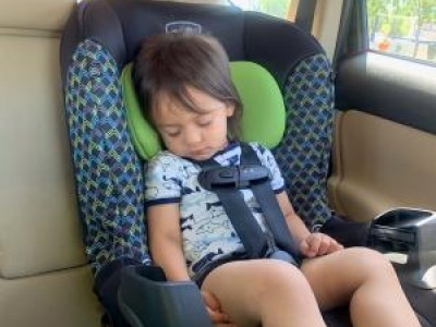 Sleeping child strapped in car seat