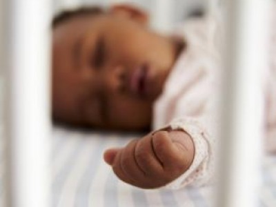 Infant sleeping in crib