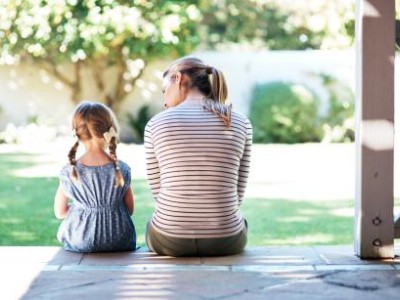 Mother and child sitting on patio