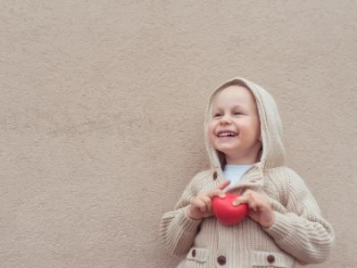 Child holding a small red ball