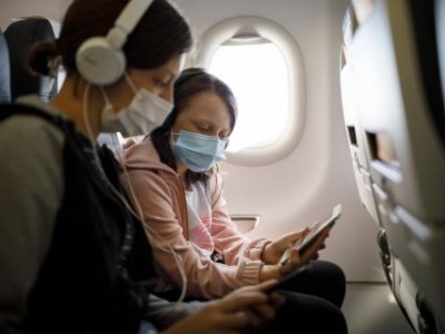 Masked travelers in an airplane