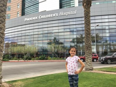 Girl standing in front of hospital