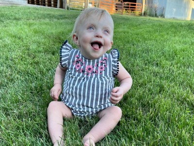 Baby girl sitting in the grass