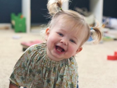 Toddler on floor, playing with toys