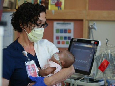 NICU nurse holding baby