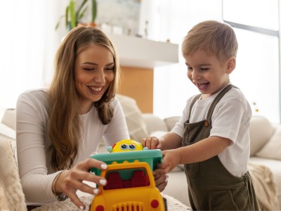 Mother and son playing with toy car