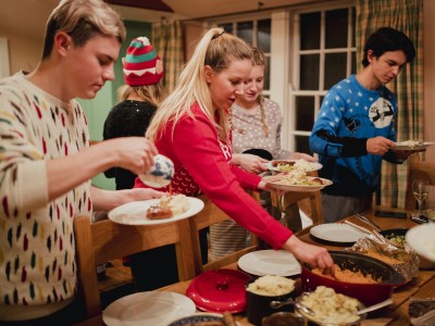 Family filling their plates at buffet table