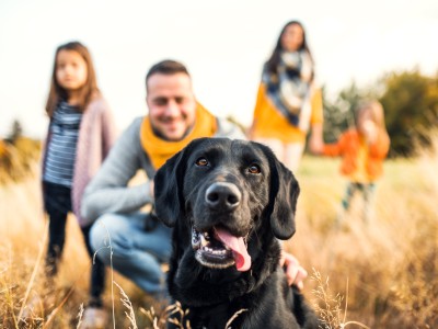 Family photo with black dog in foreground