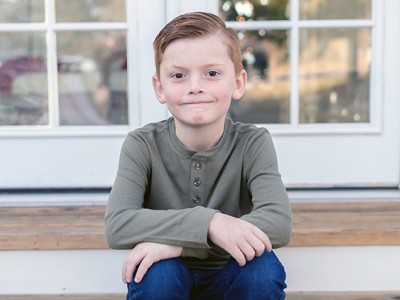 Young boy sitting on steps