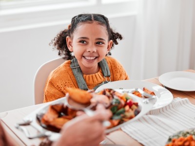 Girl smiling at dinner table